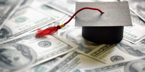 Graduation cap on top of money